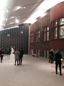 A Gallery showing part of the original exposed brickwork and Sarah Lucas's 'Tits in Space' wallpaper